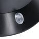 A close-up of a black plastic lid with a white button on a Bunn My Cafe pod brewer.