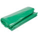 A green plastic garbage bag on a white background.
