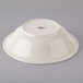 A white Tuxton china pasta bowl on a gray surface.