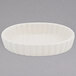 A white oval dish with a scalloped edge.