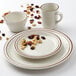 A Tuxton Bahamas narrow rim china plate and cup with a brown speckle design.