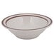 A white bowl with brown speckled narrow rim.