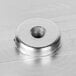 A close-up of a stainless steel Avantco slicer blade cover nut.