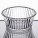 A clear fluted plastic ramekin with a rim on top.