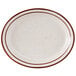 A white plate with brown speckled narrow rim.