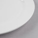 A close-up of a Libbey Bright White Porcelain Plate with a white rim.