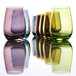 A group of Stolzle olive stemless wine glasses on a table.