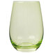 A close up of a Stolzle green stemless wine glass with a clear glass and green liquid.