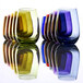 A row of green, blue, and purple Stolzle stemless wine glasses on a white table.