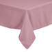 A close-up of a pink square Intedge tablecloth with a hemmed edge.