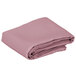 A folded pink Intedge cloth tablecloth.