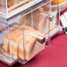 A clear Cal-Mil acrylic bread case with two drawers holding bread.