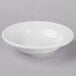 A Libbey Basics Orbis bright white porcelain fruit bowl with a rim on a white surface.