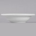 A Libbey bright white porcelain fruit bowl on a white surface.