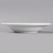 A Libbey Basics Orbis bright white porcelain soup bowl with a white rim on a white surface.