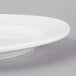 A close up of a Libbey Bright White oval porcelain platter with a rim.