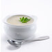 A bowl of Silver Skillet cream of celery soup with a silver spoon on the side.