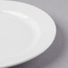 A close-up of a Libbey bright white porcelain plate with a white rim.