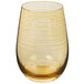 A close up of a Stolzle amber stemless wine glass with a yellow pattern.
