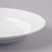 A close-up of a Libbey bright white porcelain pasta bowl with a rim.