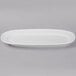 A close up of a Libbey Bright White oval porcelain racetrack platter with a small rim.
