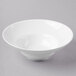 A Libbey white bowl with a white rim on a white surface.