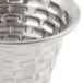 A close up of a Tablecraft stainless steel sauce cup with a patterned design on the metal.