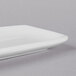 A close-up of a Libbey Bright White rectangular porcelain tray.