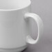 A close-up of a Libbey bright white porcelain mug with a white handle.