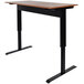 A black and brown Luxor stand up desk with a black base.