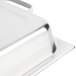 A Vollrath stainless steel hinged dome lid on a metal tray.
