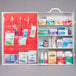 A white Medique first aid kit cabinet with red labeling.