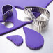 A close-up of a Ateco stainless steel fluted comma cookie cutter set.