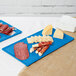 A Tablecraft sky blue cast aluminum rectangular cooling platter with meat and cheese on it.