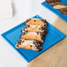 A Tablecraft sky blue cast aluminum rectangular cooling platter with pastries on it.