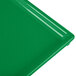 A close-up of a green Tablecraft rectangular cast aluminum cooling platter.