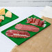 Two Tablecraft green cast aluminum rectangular trays of meat and cheese.