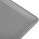 A close up of a granite cast aluminum Tablecraft rectangular cooling platter with a grey background.