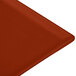 A Tablecraft copper cast aluminum rectangular cooling platter on a red surface.