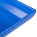 A close-up of a cobalt blue Tablecraft cast aluminum flared rectangular platter.