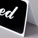 A black and white Table Tent sign with white letters reading "Reserved"