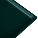 A hunter green rectangular metal cooling platter with white speckles.