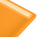 A close-up of a Tablecraft orange rectangular cast aluminum cooling platter.