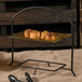 A Clipper Mill black iron powder coated 2 tier table riser with food on it.