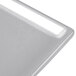 A close-up of a natural cast aluminum rectangular cooling platter on a white surface.
