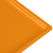 A close-up of an orange rectangular Tablecraft cooling platter.