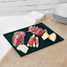 A Tablecraft hunter green cast aluminum rectangular cooling platter with meat and cheese on it.