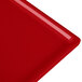 A red rectangular Tablecraft cast aluminum cooling platter with a thin edge.