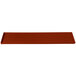 A copper rectangular cast aluminum cooling platter with a white border and a red handle.