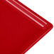 A red cast aluminum rectangular cooling platter.